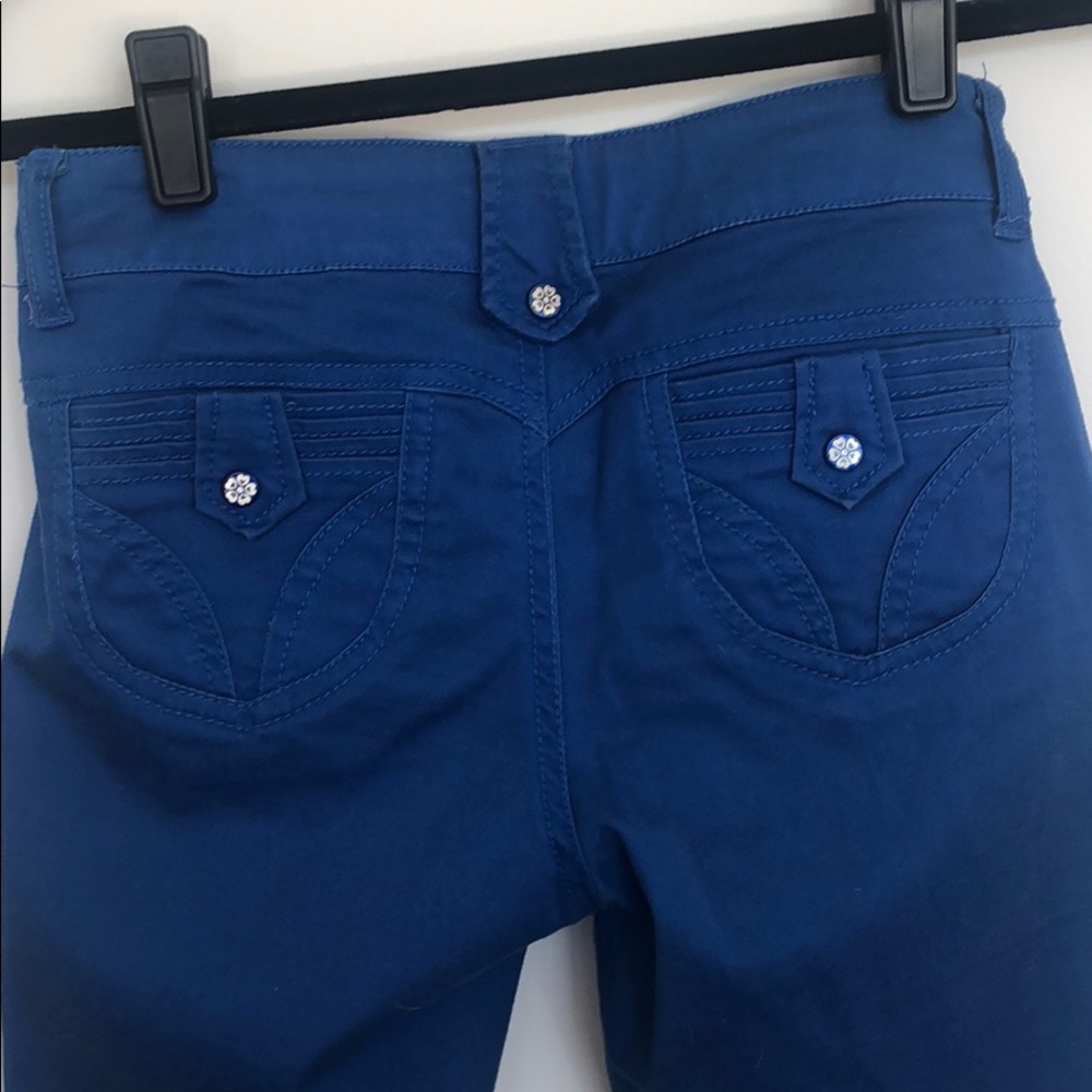 Blue pants with mother of pearl like button detail